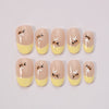Unghie finte gialle Dolce Ape di Blubella con french tip e decorazioni naturali